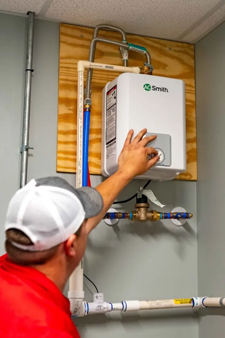 Airstream Services technician adjusting a tankless water heater during a repair service in a Middle Tennessee home.