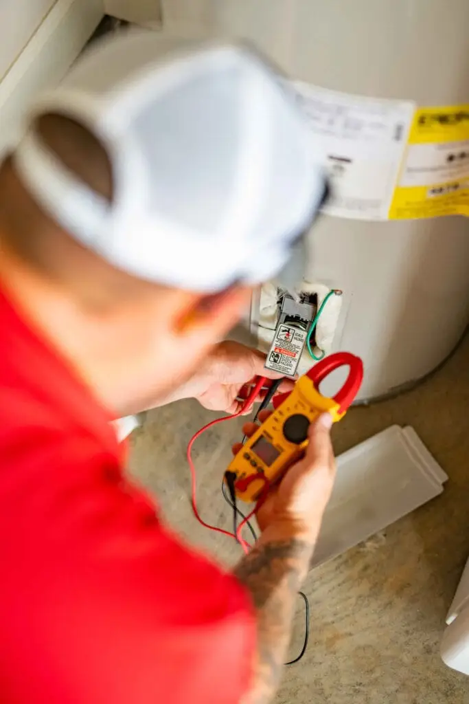 Airstream Services technician using a multimeter to test electrical components on a residential water heater in Middle Tennessee.