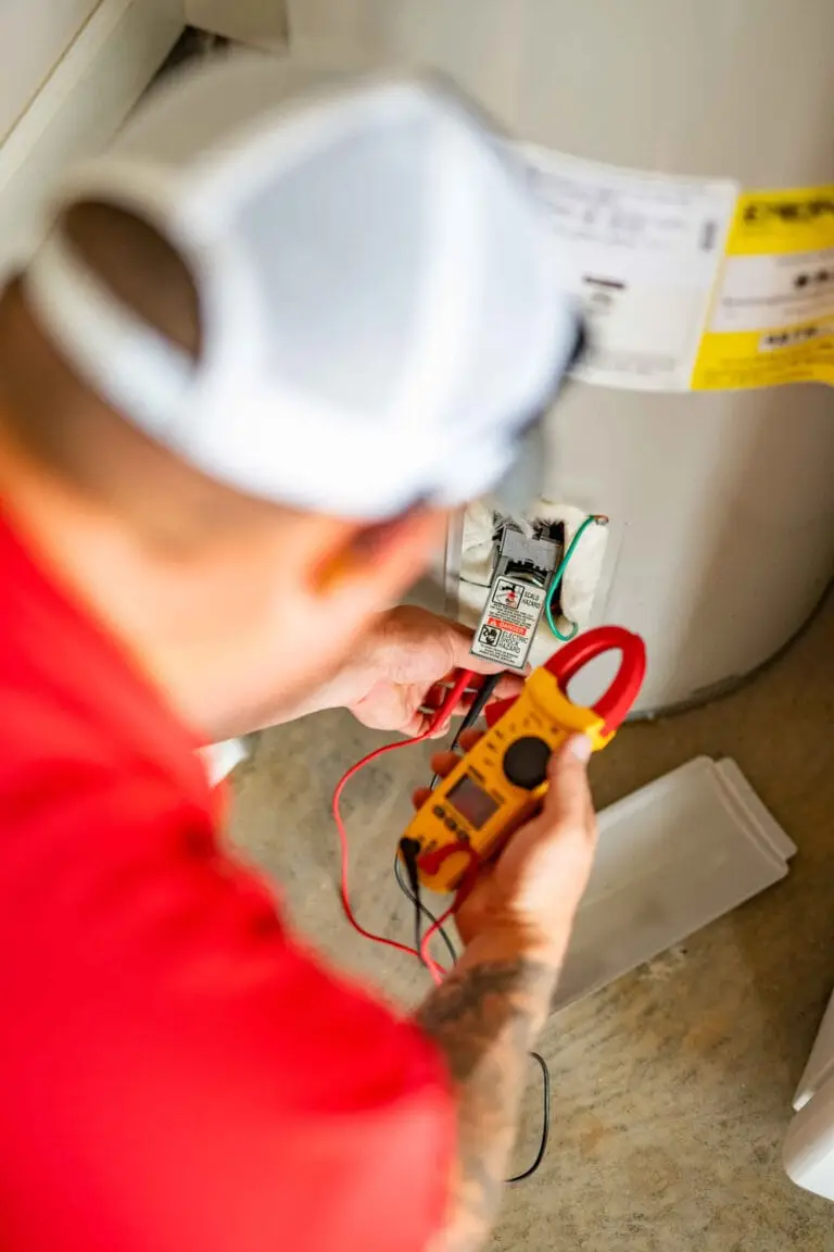 Airstream Services technician using a multimeter to test electrical components on a residential water heater in Middle Tennessee.