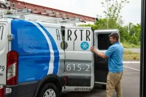 Airstream Services technician standing beside an electrical service van, ready to assist homeowners with electrical repairs and safety inspections.
