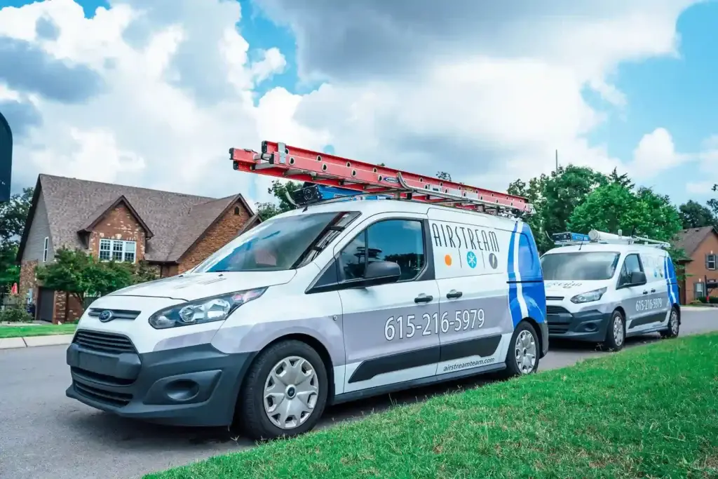 Airstream Services branded service vans parked in a Middle Tennessee neighborhood for HVAC, plumbing, and electrical appointments