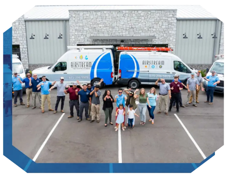 Airstream Plumbing, Heating & Air team and family stand in front of branded service vans.