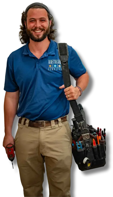 Smiling Airstream Plumbing, Heating & Air technician wearing a tool belt and holding a drill, ready for electrical service.