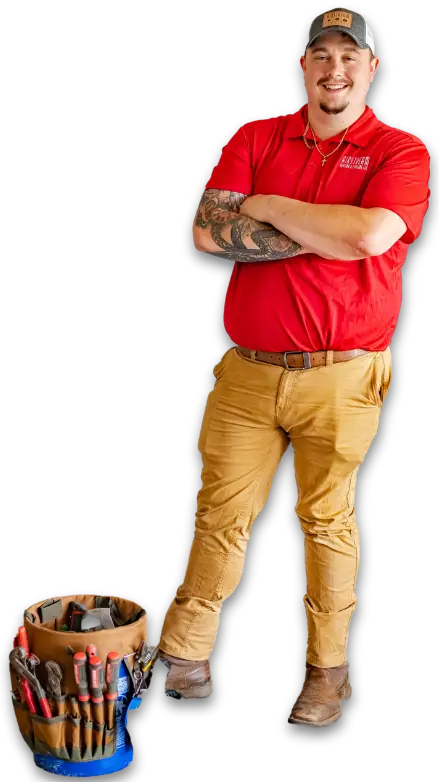Smiling Airstream Plumbing, Heating & Air technician in a red polo with arms crossed, leaning on a bucket of tools.